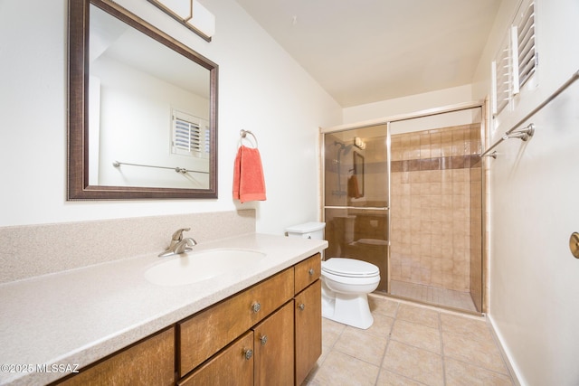 bathroom featuring a shower with door, vanity, tile patterned flooring, and toilet