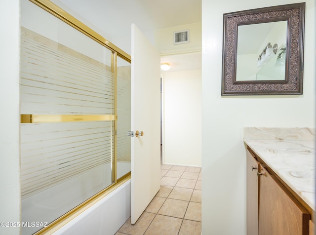 bathroom featuring vanity, tile patterned floors, and shower / bath combination with glass door