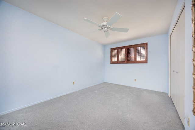 unfurnished room featuring ceiling fan and light carpet