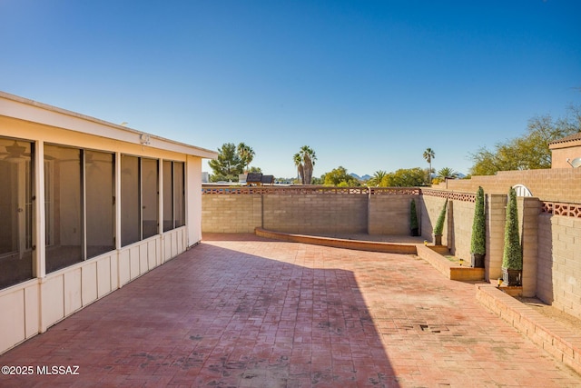 view of patio featuring a sunroom