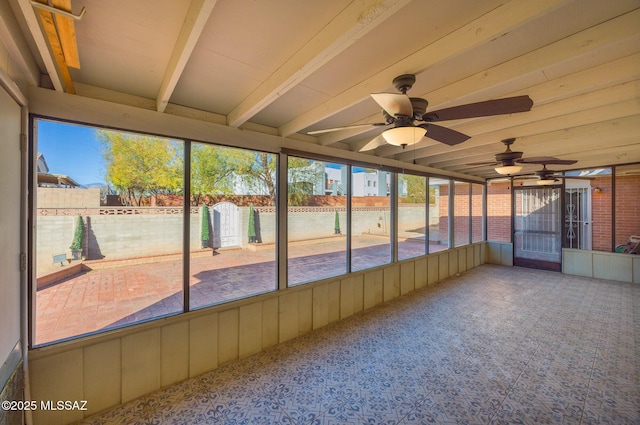 unfurnished sunroom with beam ceiling