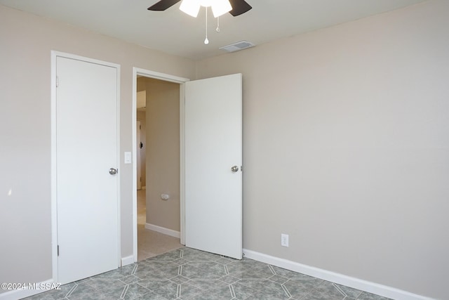 spare room featuring ceiling fan and light tile patterned floors