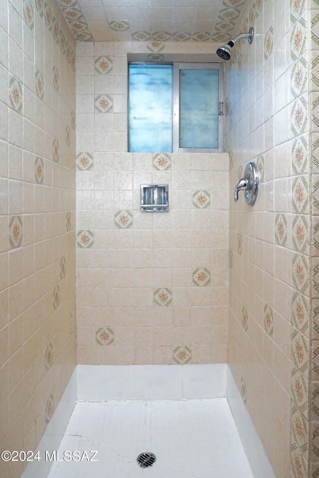 bathroom with a tile shower