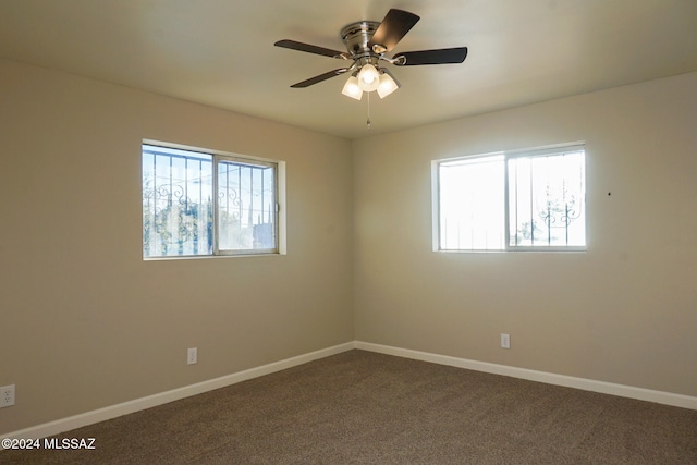 spare room featuring ceiling fan, carpet, and a healthy amount of sunlight