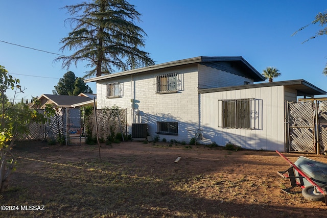 rear view of property featuring cooling unit