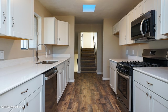 kitchen featuring white cabinets, sink, dark hardwood / wood-style floors, and stainless steel appliances