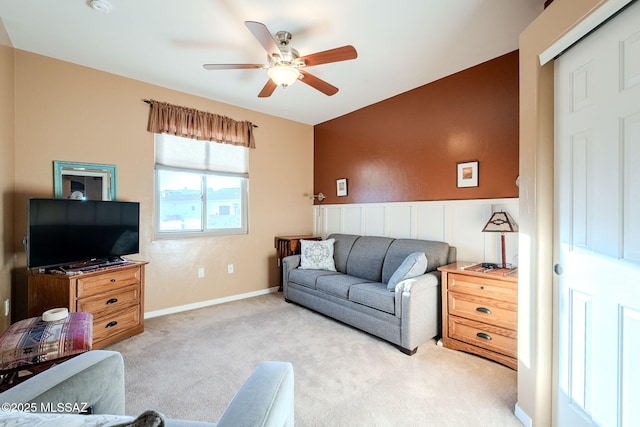 carpeted living area featuring a ceiling fan