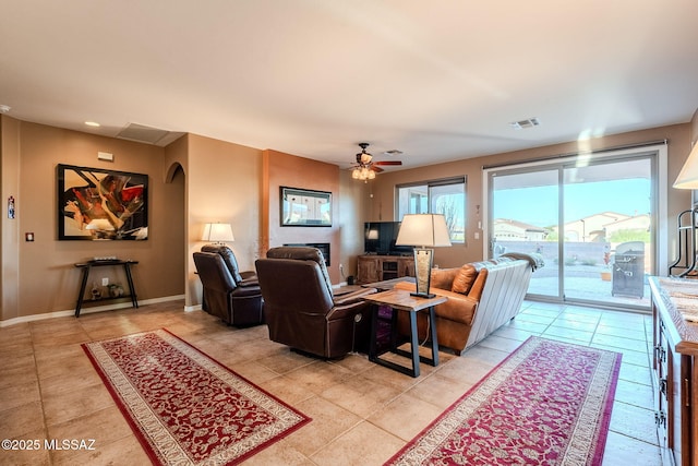 living room with ceiling fan, baseboards, light tile patterned flooring, and visible vents