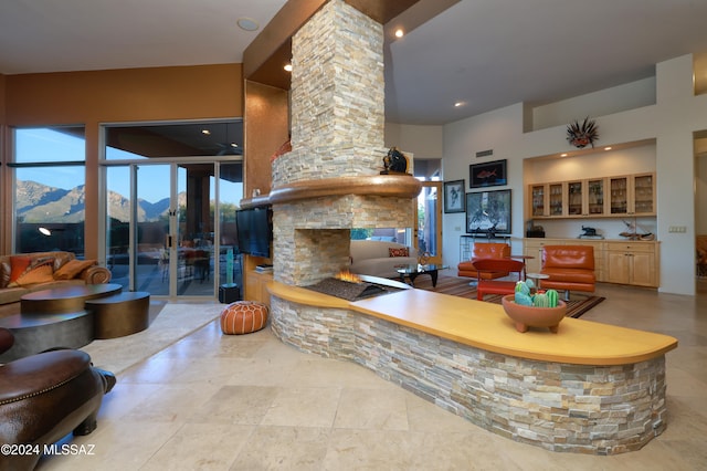 kitchen with a mountain view, a fireplace, and light brown cabinetry