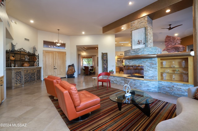 living area featuring light tile patterned flooring, a stone fireplace, visible vents, and recessed lighting