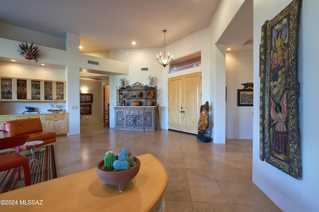 tiled entrance foyer featuring a chandelier, visible vents, and recessed lighting