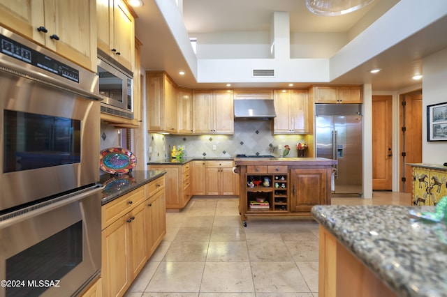 kitchen with visible vents, built in appliances, under cabinet range hood, decorative backsplash, and recessed lighting
