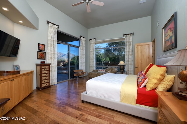 bedroom featuring access to outside, hardwood / wood-style flooring, and ceiling fan