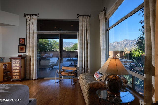 interior space featuring ceiling fan, a mountain view, and hardwood / wood-style flooring