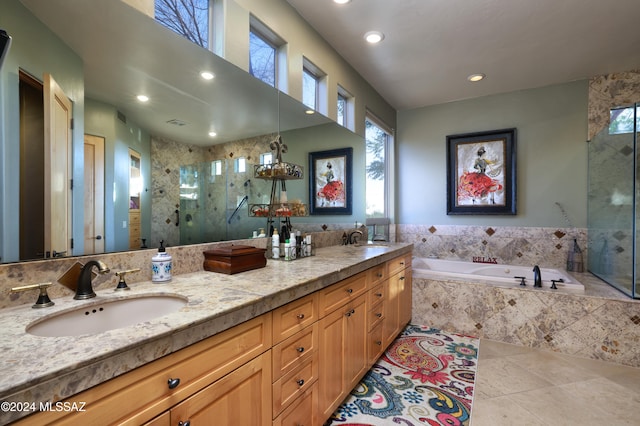 bathroom with a stall shower, a garden tub, recessed lighting, and a sink