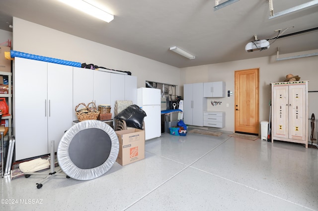 garage featuring a garage door opener and white refrigerator