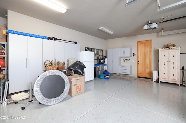 garage with freestanding refrigerator and a garage door opener