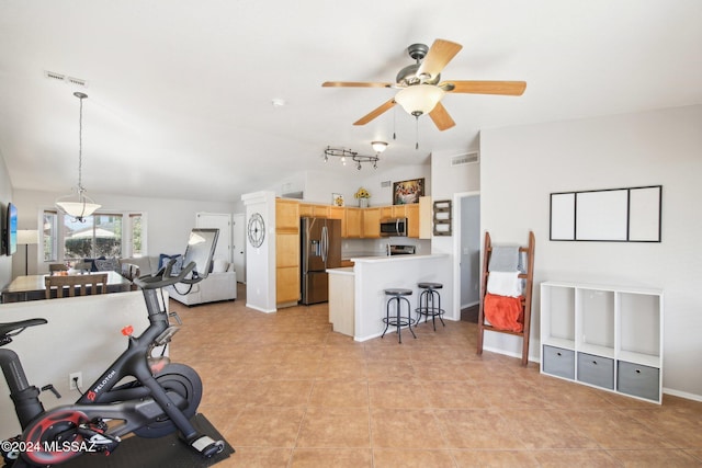 exercise room with light tile patterned floors, ceiling fan, and lofted ceiling