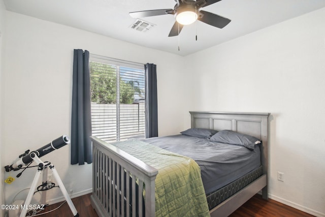 bedroom with ceiling fan and dark hardwood / wood-style flooring