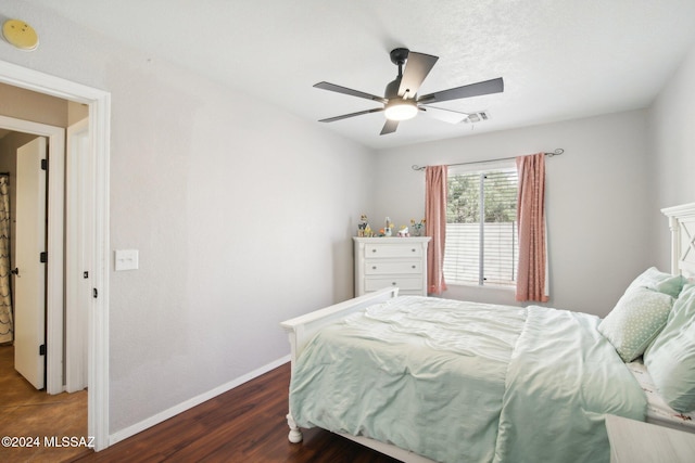 bedroom featuring ceiling fan and dark hardwood / wood-style flooring