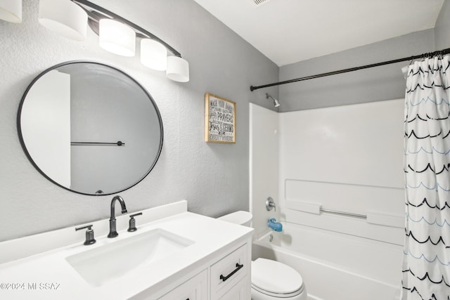 full bathroom featuring vanity, shower / bath combination with curtain, and toilet