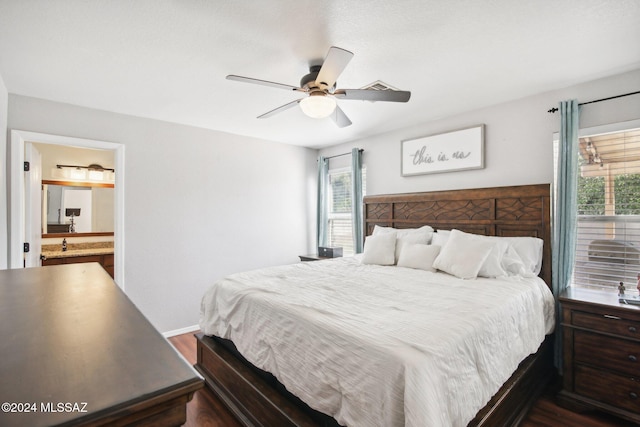 bedroom featuring hardwood / wood-style flooring, ensuite bathroom, ceiling fan, and multiple windows