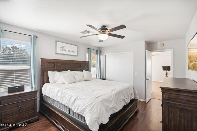 bedroom featuring multiple windows, ceiling fan, and dark wood-type flooring