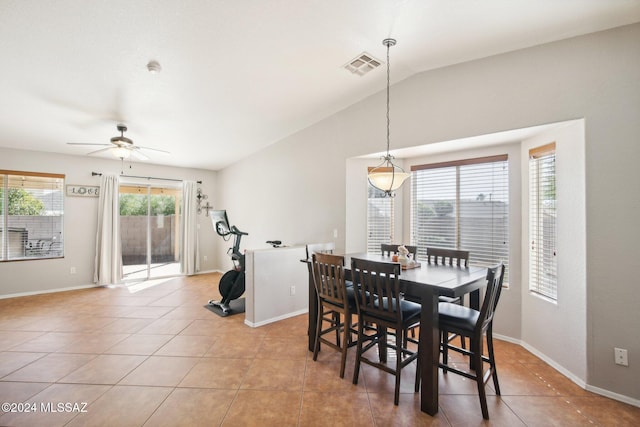 dining room featuring light tile patterned floors, vaulted ceiling, and ceiling fan