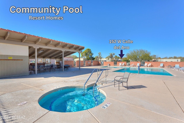 view of pool featuring a community hot tub and a patio area