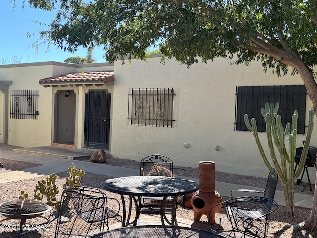 exterior space with an outdoor fire pit and a patio