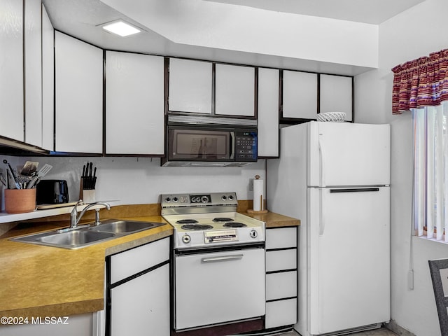 kitchen featuring white cabinets, white appliances, and sink