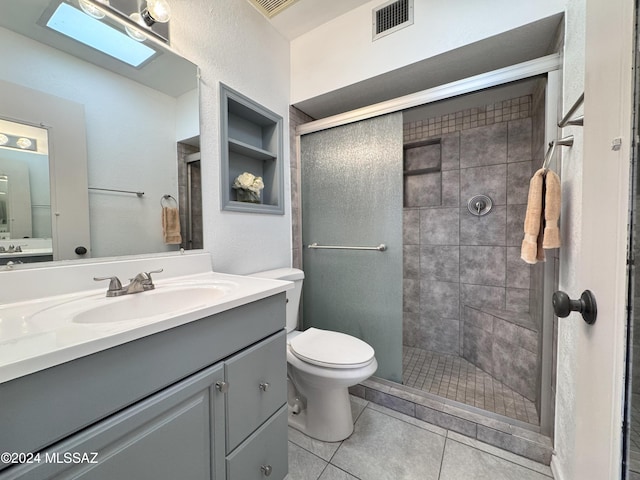 bathroom with a skylight, tile patterned floors, an enclosed shower, toilet, and vanity