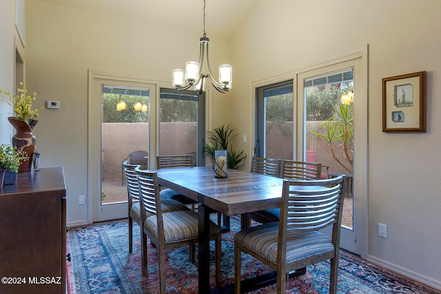 dining space with a notable chandelier and vaulted ceiling