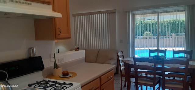 kitchen featuring gas range gas stove and light tile patterned flooring