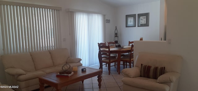 tiled living room featuring lofted ceiling