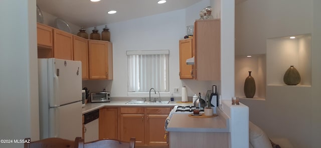 kitchen featuring light brown cabinets, white appliances, and sink