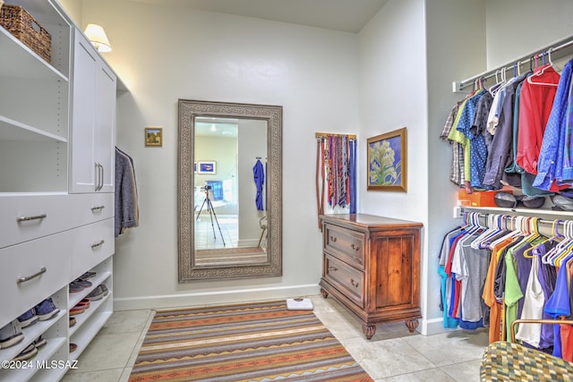 walk in closet featuring light tile patterned flooring