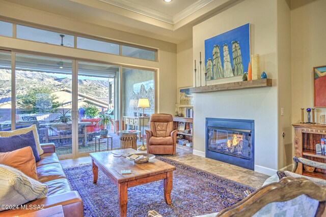 living room with tile patterned flooring and ornamental molding