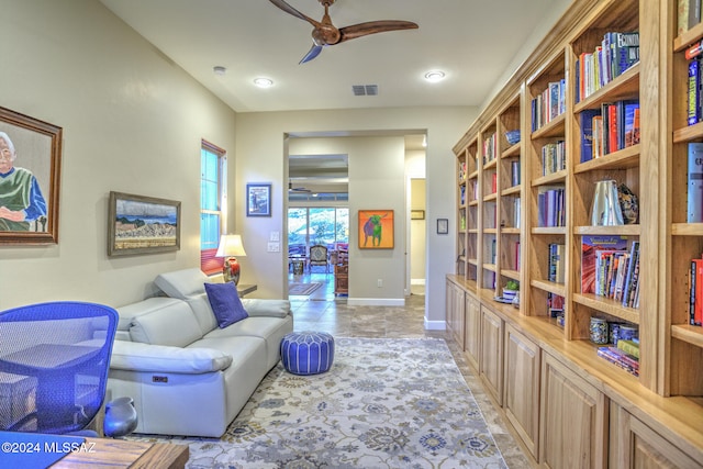 living area featuring ceiling fan