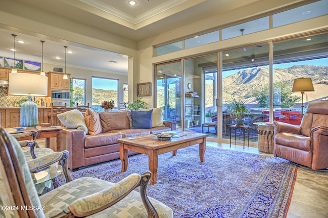 tiled living room with a mountain view and ornamental molding