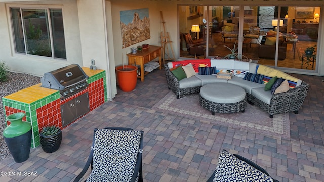 view of patio with area for grilling, an outdoor living space, and grilling area