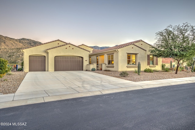 mediterranean / spanish house with a mountain view and a garage