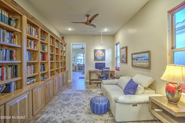 sitting room featuring ceiling fan and light tile patterned flooring