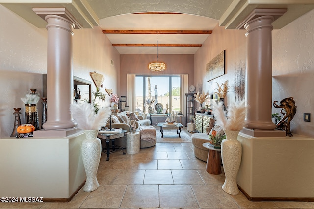 living room with an inviting chandelier, light tile patterned floors, ornate columns, and beam ceiling