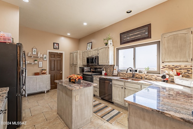 kitchen featuring sink, appliances with stainless steel finishes, decorative backsplash, and a center island