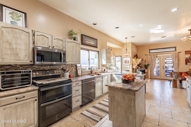 kitchen featuring tasteful backsplash, pendant lighting, a chandelier, and stainless steel appliances