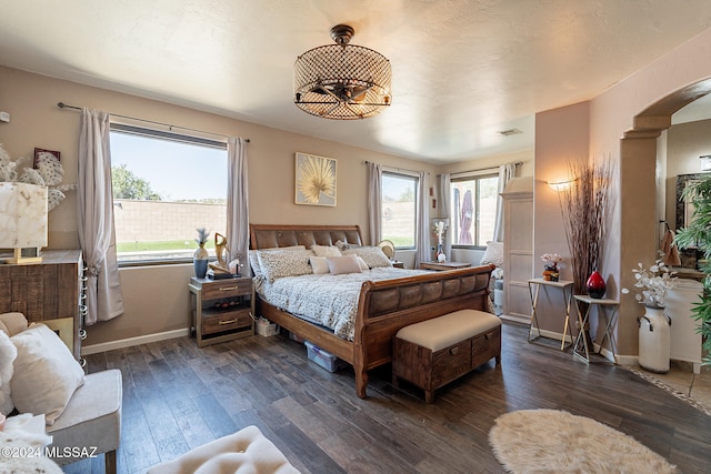 bedroom with dark hardwood / wood-style flooring