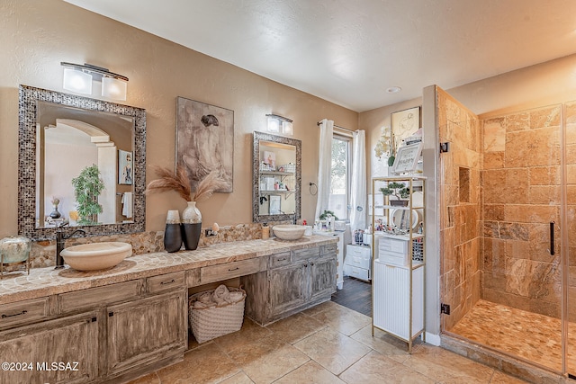 bathroom with vanity and a shower with door