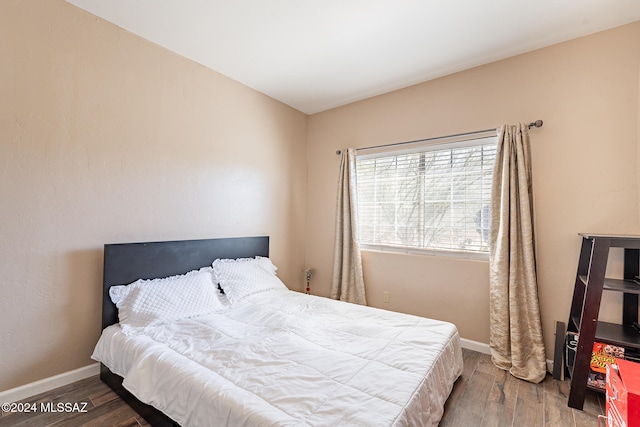 bedroom with hardwood / wood-style flooring