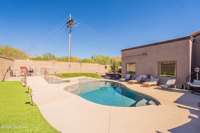 view of swimming pool with a patio area